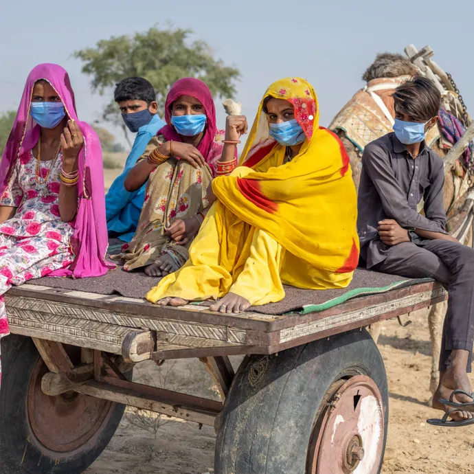 People in a hard-to-reach area of Rajasthan, India are transported by camel cart to get their COVID-19 vaccination.