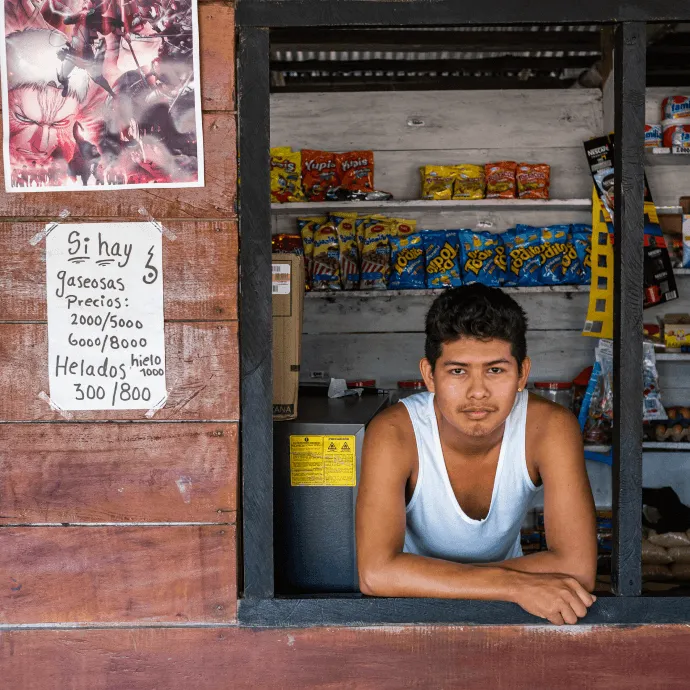 Jean Carlos poses in his mother's store where he works in the indigenous community of Concordia, Colombia.