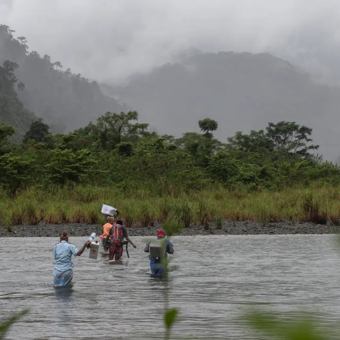 The team cross the Kuvamiti River to reach residents.