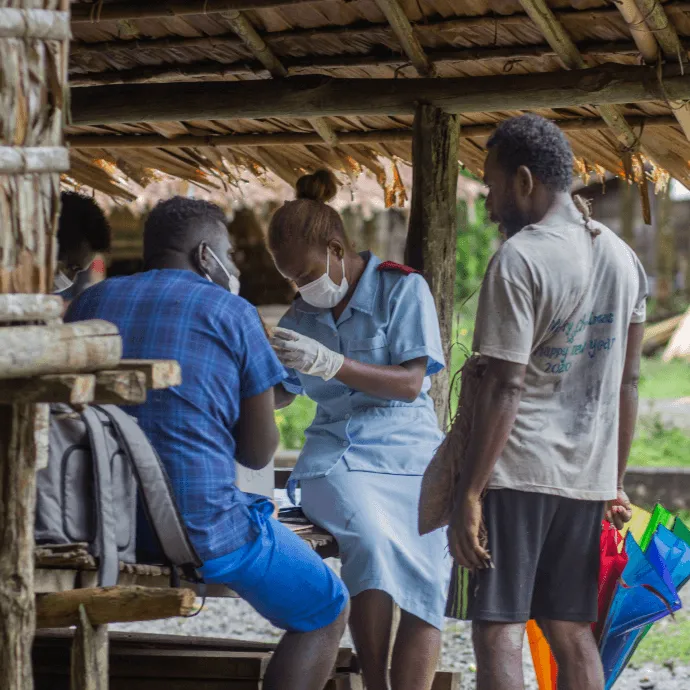 Nurse Rose brings COVID-19 vaccines and other essential health services to residents of remote Kuvamiti village.