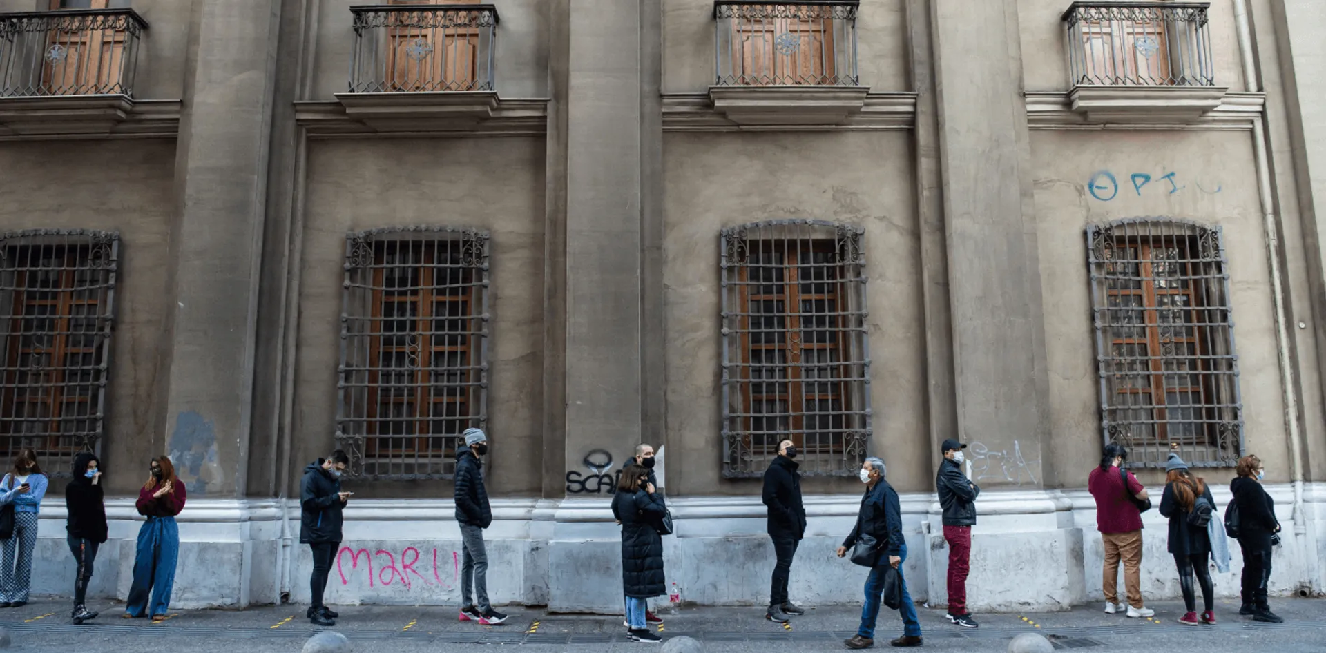 People line up outside COVID-19 vaccination centres in Santiago, Chile.